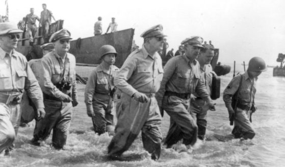 Gen. Douglas MacArthur, center, is accompanied by his officers and Sergio Osmena, president in exile of the Philippines, extreme left, as he wades ashore during landing operations at Leyte, Philippines, Oct. 20, 1944, after U.S. forces recaptured the beach of the Japanese-occupied island. To his left is Lt. Gen. Richard K. Sutherland, his chief of staff.