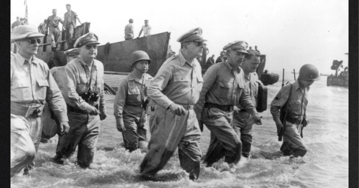 Gen. Douglas MacArthur, center, is accompanied by his officers and Sergio Osmena, president in exile of the Philippines, extreme left, as he wades ashore during landing operations at Leyte, Philippines, Oct. 20, 1944, after U.S. forces recaptured the beach of the Japanese-occupied island. To his left is Lt. Gen. Richard K. Sutherland, his chief of staff.