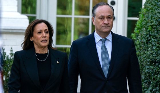 Vice President Kamala Harris, left, and second gentleman Doug Emhoff, right, arrive to deliver remarks before planting a pomegranate tree at the Vice President's residence at the U.S. Naval Observatory in Washington, D.C., on Oct. 7.