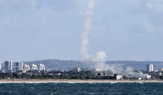 A plume of smoke billows after missiles were fired from Israel's Iron Dome missile-defense system batteries to intercept rockets over the northern city of Acre on Tuesday.