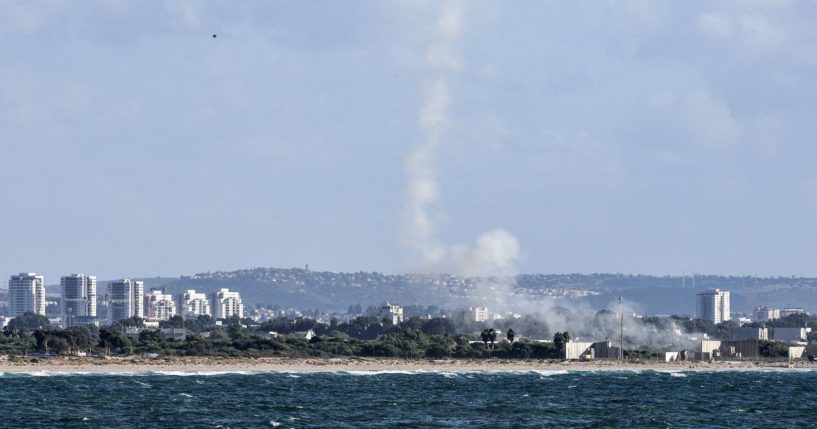 A plume of smoke billows after missiles were fired from Israel's Iron Dome missile-defense system batteries to intercept rockets over the northern city of Acre on Tuesday.