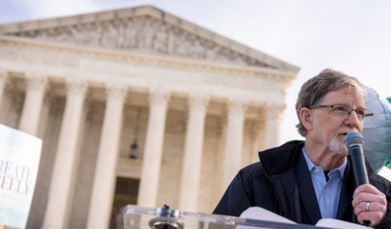 Colorado baker Jack Phillips, seen speaking to supporters outside the Supreme Court in Washington in December of 2022, said his 12 years of court cases brought by gay and transgender activists have strengthened his faith.