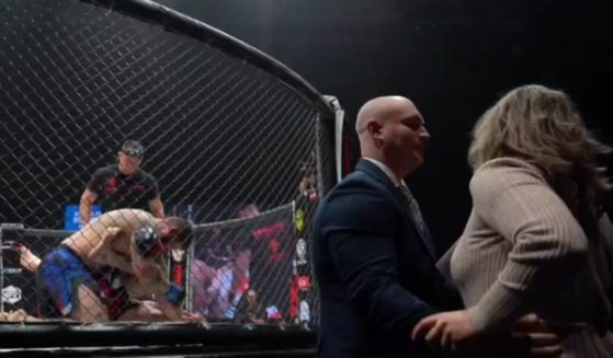 Vladimir Polozov's wife, right, rushed to the side of the ring during a fight as her husband was getting pummeled, but shortly after, Polozov won the fight by securing an armbar.