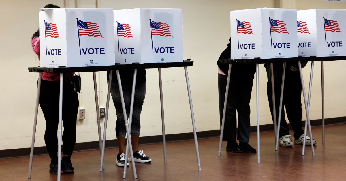 People cast their in-person early ballot for the 2024 general election at the Northwest Activities Center in Detroit, Michigan, on Tuesday.