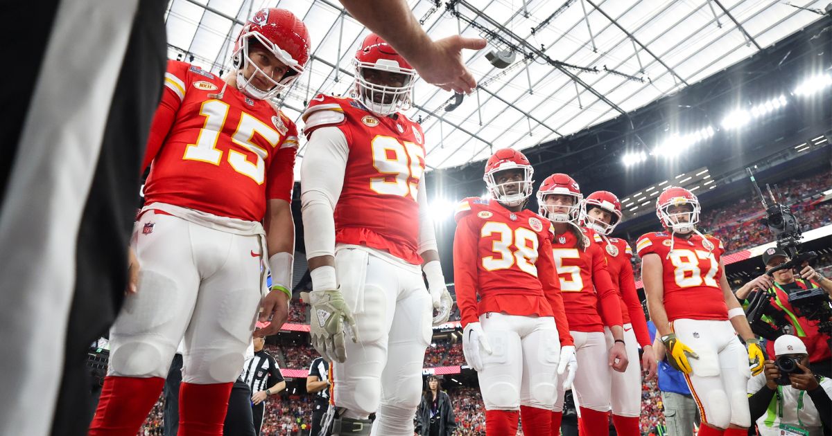 Patrick Mahomes #15, Chris Jones #95, L'Jarius Sneed #38, Tommy Townsend #5, Harrison Butker #7, and Travis Kelce #87 of the Kansas City Chiefs look on as referee Bill Vinovich (52) performs the coin toss prior to Super Bowl LVIII.