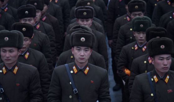 In a photo taken on December 17, 2019 Korean People's Army (KPA) soldiers hold flowers as they pay their respects before a statue of late North Korean leader Kim Jong Il, on the anniversary of his death, at Mansu Hill in Pyongyang.