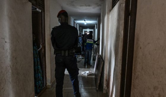 Ivorian security forces members stand guard as workers carry out occupant's belongings during an evacuation operation at the Mermoz campus after the country's Ministry of Education ordered students illegally occupying rooms in university halls of residence to vacate the premises, in Cocody, Abidjan, on October 7, 2024.