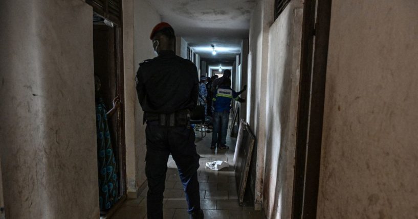 Ivorian security forces members stand guard as workers carry out occupant's belongings during an evacuation operation at the Mermoz campus after the country's Ministry of Education ordered students illegally occupying rooms in university halls of residence to vacate the premises, in Cocody, Abidjan, on October 7, 2024.