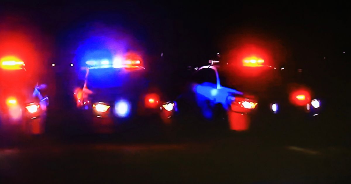 Stock photo of multiple police cars with active lights.