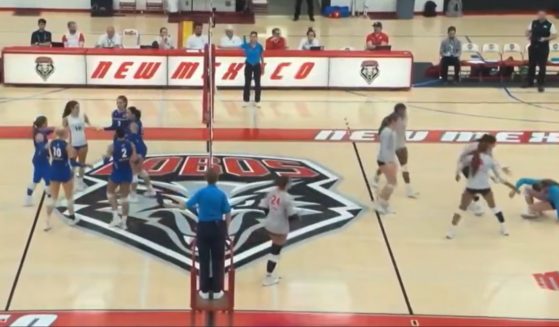 A volleyball player is knocked to the floor after a spike driven by her transgender opponent.