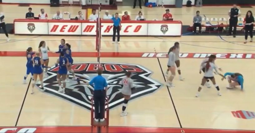 A volleyball player is knocked to the floor after a spike driven by her transgender opponent.