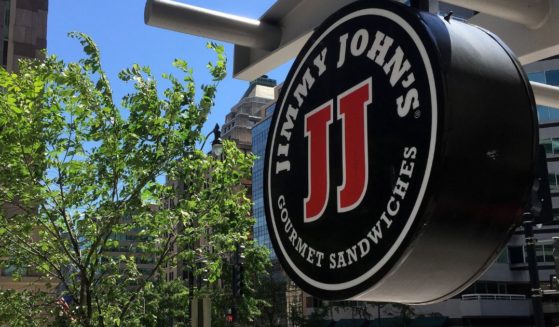 A logo of the sandwich restaurant chain, specializing in delivery Jimmy John's hangs outside one of their shops in downtown Washington, DC, June 9, 2016 A US sandwich chain is being sued for locking its low-paid workers into non-compete agreements more typical of high-tech workers or top executives.