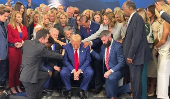 Christian leaders gathered around former President Donald Trump, center, to pray for him before a campaign rally this week.