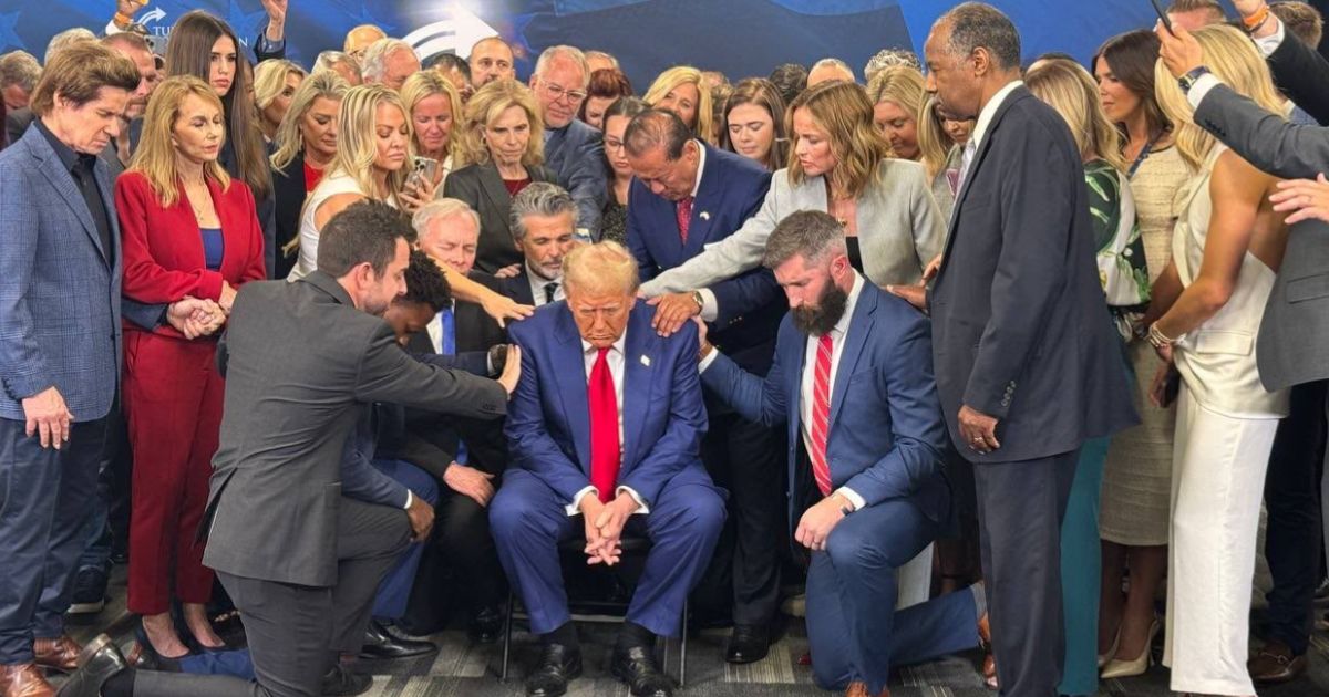 Christian leaders gathered around former President Donald Trump, center, to pray for him before a campaign rally this week.