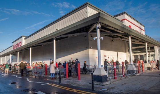 Shoppers queue outside a Costco store on Dec. 20, 2022.