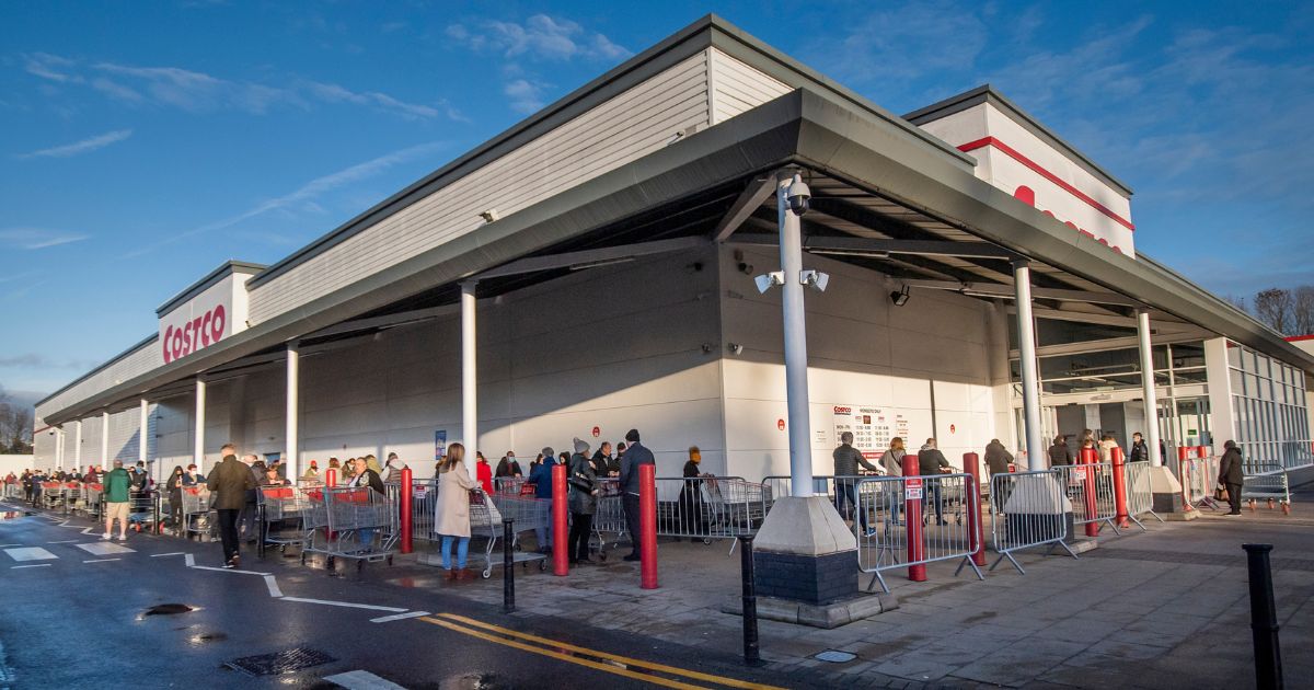 Shoppers queue outside a Costco store on Dec. 20, 2022.