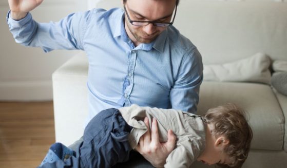 This stock image shows a father disciplining his young son.