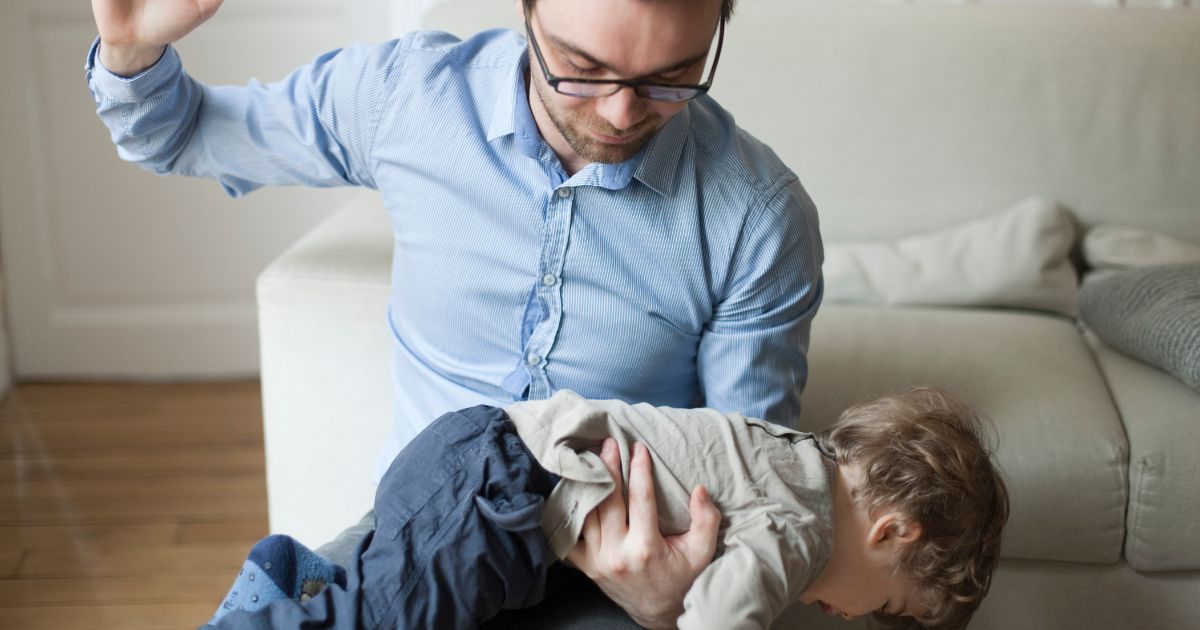 This stock image shows a father disciplining his young son.