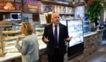 Democratic vice presidential candidate Minnesota Gov. Tim Walz and his wife Gwen Walz , left, visit Justino's Pizzeria after his debate with Republican vice presidential candidate Sen. JD Vance of Ohio Tuesday in New York City.