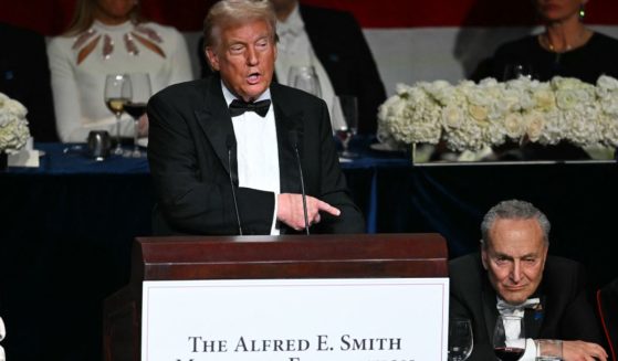 Former President Donald Trump, left, gestures to Senate Majority Leader Chuck Schumer, right, during his speech at the Al Smith Dinner in New York City on Thursday.