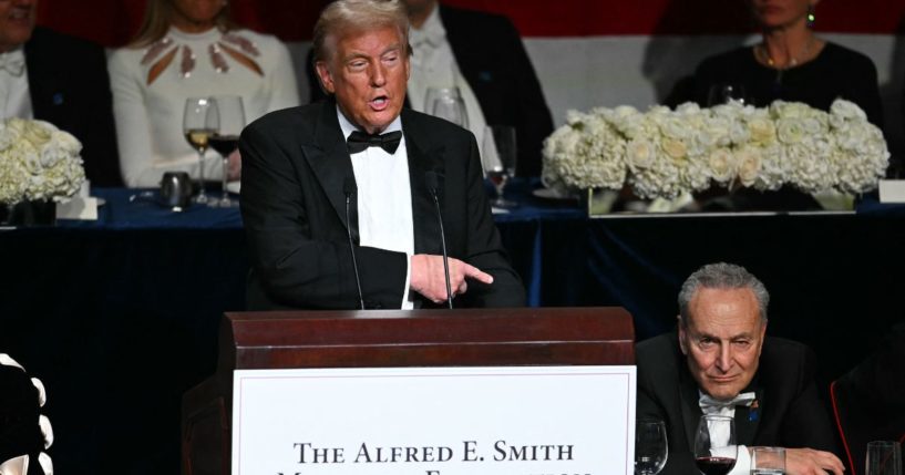 Former President Donald Trump, left, gestures to Senate Majority Leader Chuck Schumer, right, during his speech at the Al Smith Dinner in New York City on Thursday.