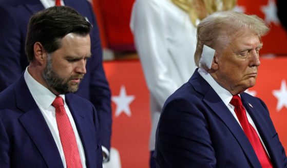 Republican vice presidential candidate J.D. Vance, left, and former President Donald Trump bow in prayer during the last day of the 2024 Republican National Convention on July 18.