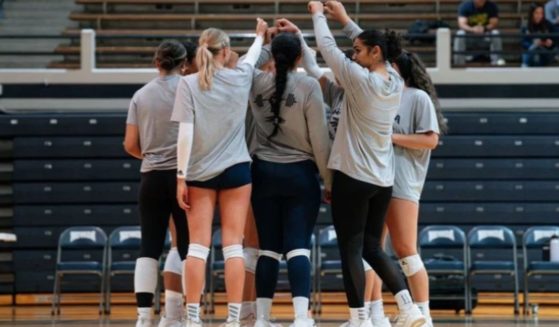 The University of Nevada, Reno women's volleyball team huddles up.