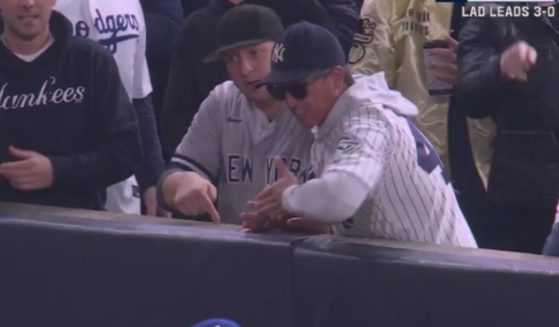 Yankees fans Austin Capobianco and John Peter were kicked out of Game 4 of World Series on Tuesday after they interfered with an outfield catch.