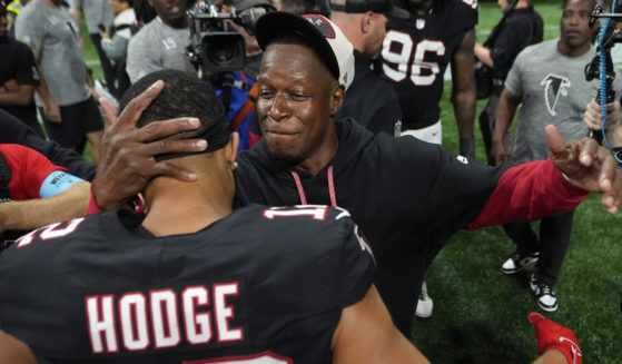 Atlanta Falcons head coach Raheem Morris celebrates with wide receiver KhaDarel Hodge after scoring against the Tampa Bay Buccaneers during overtime in an NFL football game, Thursday, Oct. 3, 2024 in Atlanta.