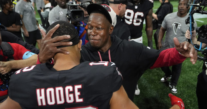 Atlanta Falcons head coach Raheem Morris celebrates with wide receiver KhaDarel Hodge after scoring against the Tampa Bay Buccaneers during overtime in an NFL football game, Thursday, Oct. 3, 2024 in Atlanta.