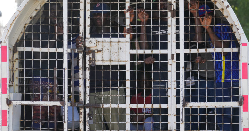 Undocumented Haitians detained by immigration officials stand inside a police vehicle, in Dajabon, Dominican Republic, in a file photo from May 17.