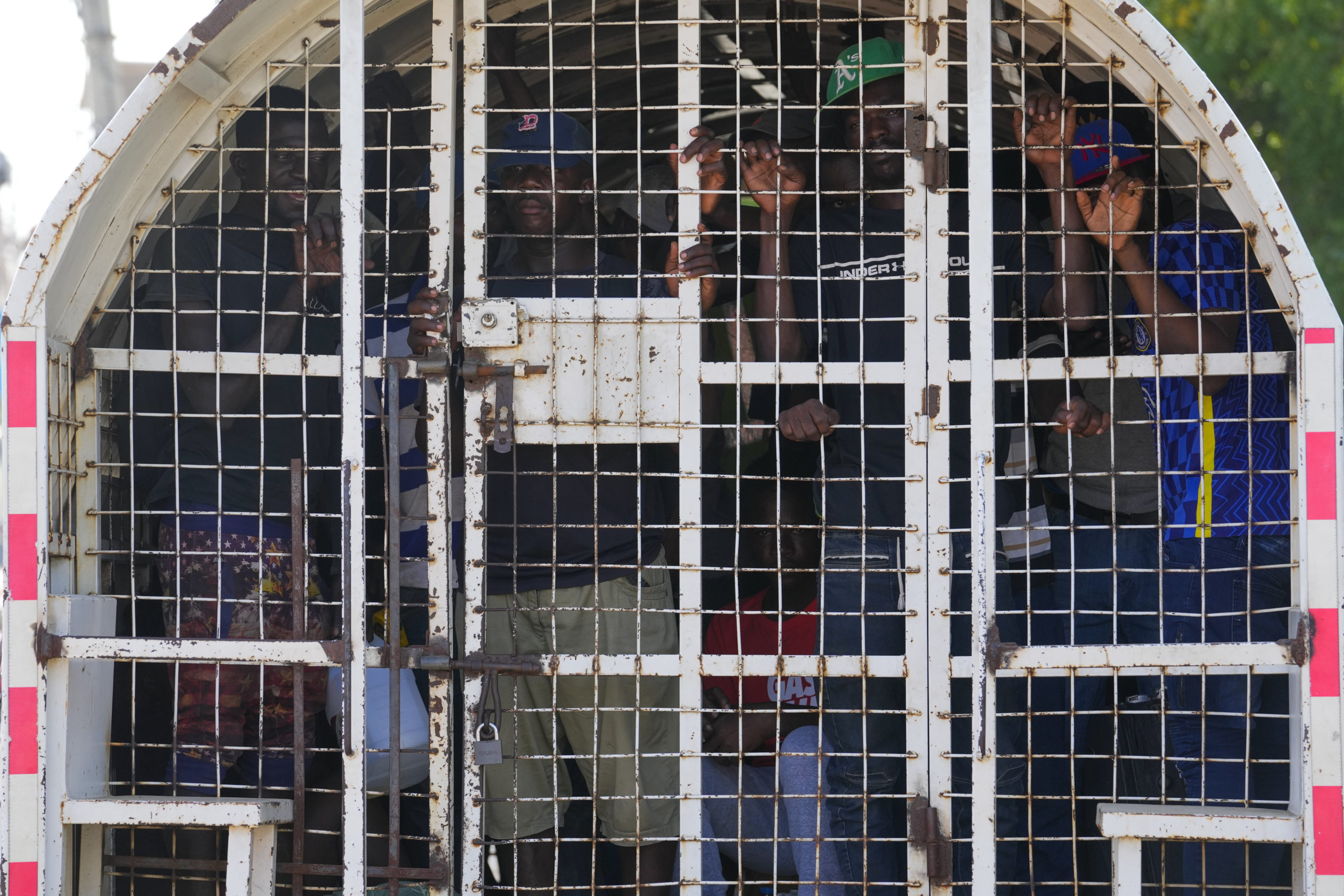 Undocumented Haitians detained by immigration officials stand inside a police vehicle, in Dajabon, Dominican Republic, in a file photo from May 17.