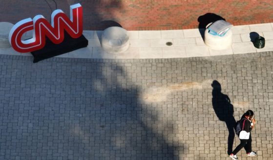 In an aerial view, a person walks past a CNN logo outside of their studios inside the Turner Entertainment Networks as final preparations are made for the CNN presidential debate on June 26, 2024 in Atlanta, Georgia.