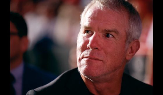 Former NFL quarterback Brett Favre listens to Republican presidential nominee, former President Donald Trump speak during a campaign event at the Resch Center on October 30, 2024 in Green Bay, Wisconsin.