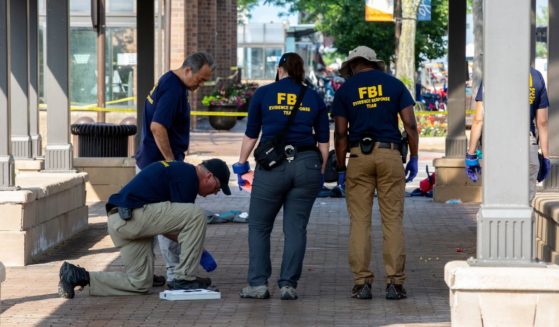 FBI agents work the scene of a shooting at a Fourth of July parade on July 5, 2022 in Highland Park, Illinois.