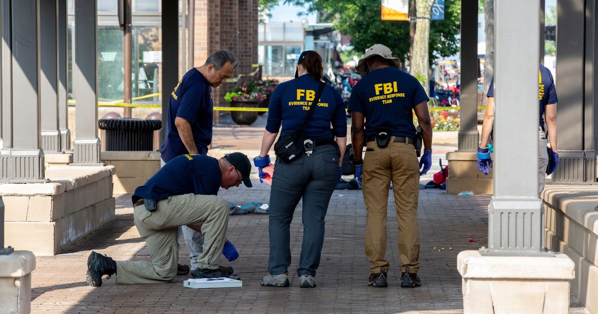 FBI agents work the scene of a shooting at a Fourth of July parade on July 5, 2022 in Highland Park, Illinois.