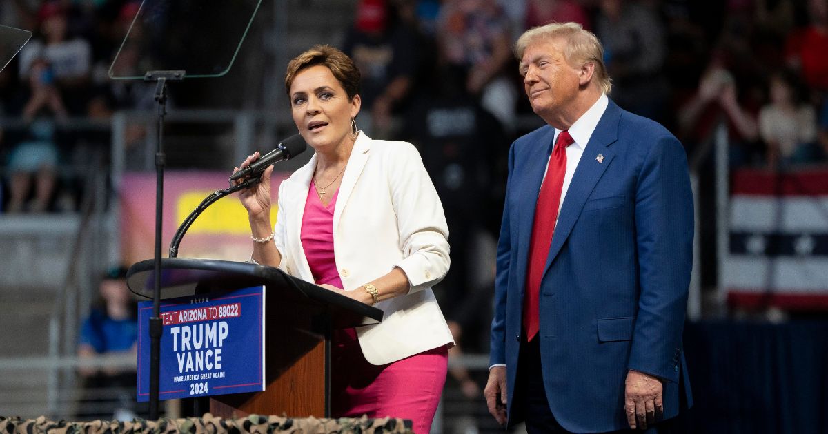 U.S. Republican presidential nominee, former President Donald Trump invites Arizona Republican U.S. Senate candidate Kari Lake on stage during a campaign rally at Findlay Toyota Center on October 13, 2024 in Prescott Valley, Arizona.