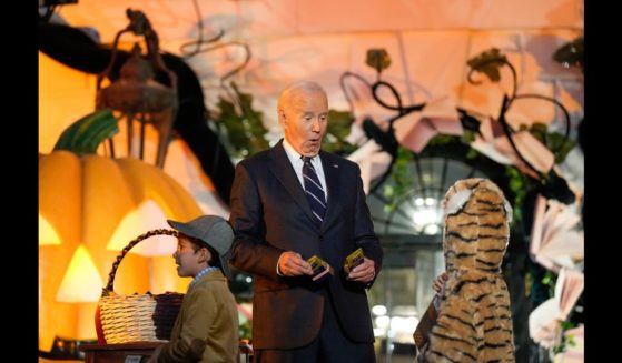 US President Joe Biden greets a trick-or-treater during a Halloween event at the White House on October 30, 2024 in Washington, DC.