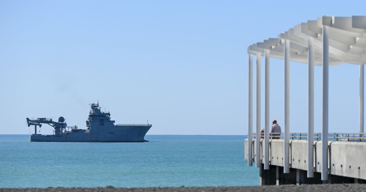 The HMNZS Manawanui sits offshore before the memorial service on February 14, 2024 in Napier, New Zealand.