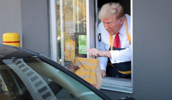 Republican presidential nominee, former U.S. President Donald Trump works the drive-through line as he visits a McDonald's restaurant on October 20, 2024 in Feasterville-Trevose, Pennsylvania.