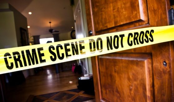 This Getty stock image shows yellow police tape in front of a crime scene.