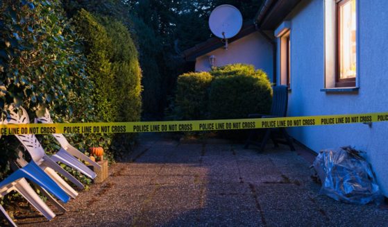 This Getty stock image shows police tape surrounding the yard of a house.