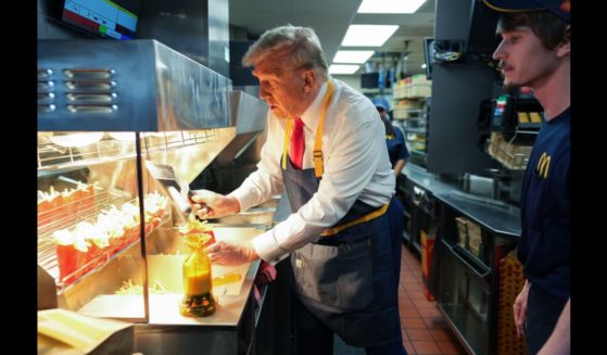 Republican presidential nominee, former U.S. President Donald Trump works behind the counter making french fries during a campaign event at McDonald's restaurant on October 20, 2024 in Feasterville-Trevose, Pennsylvania.