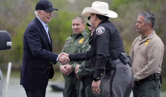 President Joe Biden, left, talks with the U.S. Border Patrol and local officials, as he looks over the southern border in Brownsville, Texas, on Feb. 29.