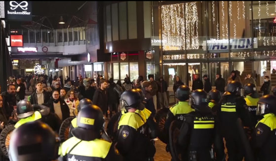 Police stand guard, forming a line near the Ajax stadium, in Amsterdam, the Netherlands, on Thursday,