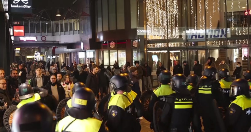 Police stand guard, forming a line near the Ajax stadium, in Amsterdam, the Netherlands, on Thursday,