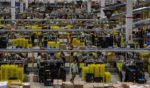 Workers work in the inbound area of the Amazon MPX5 fulfillment center in Castel San Giovanni, Italy, on Nov. 17, 2017.