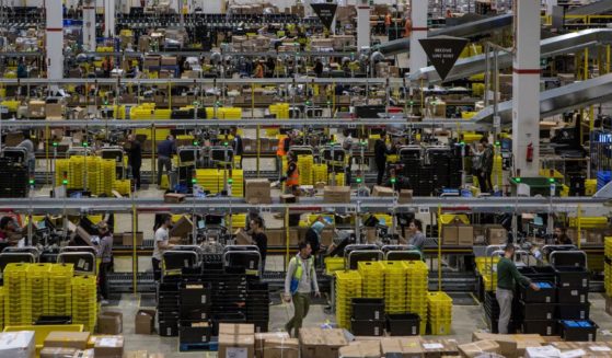 Workers work in the inbound area of the Amazon MPX5 fulfillment center in Castel San Giovanni, Italy, on Nov. 17, 2017.