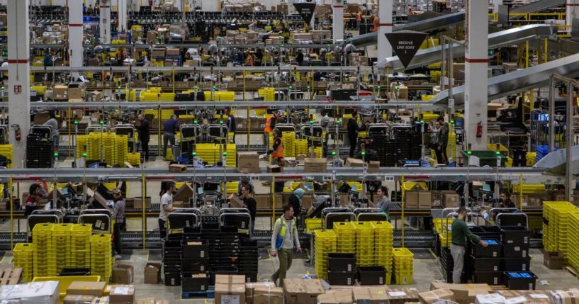 Workers work in the inbound area of the Amazon MPX5 fulfillment center in Castel San Giovanni, Italy, on Nov. 17, 2017.