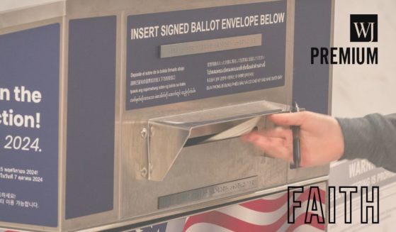 A voter drops off a ballot at an official ballot drop box at the San Francisco City Hall voting center in San Francisco, California, on Monday.